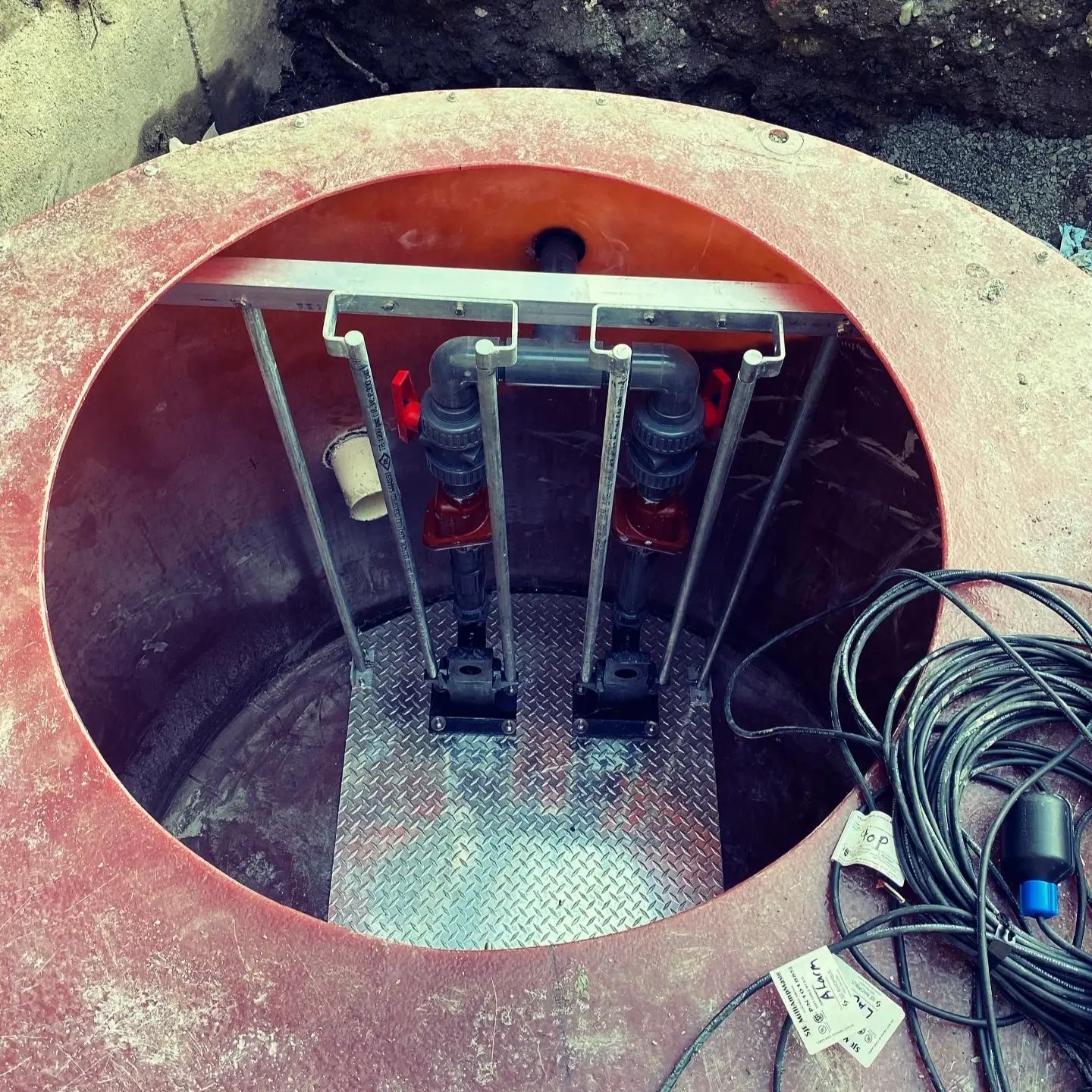 Concrete lift station installation with exposed underground infrastructure